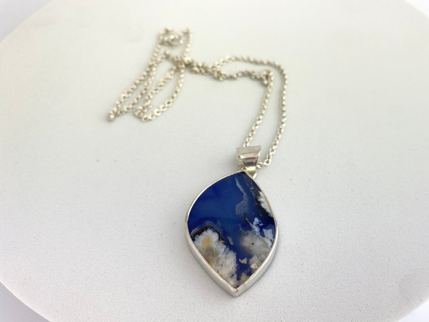 Necklace with a blue pendant on a white background