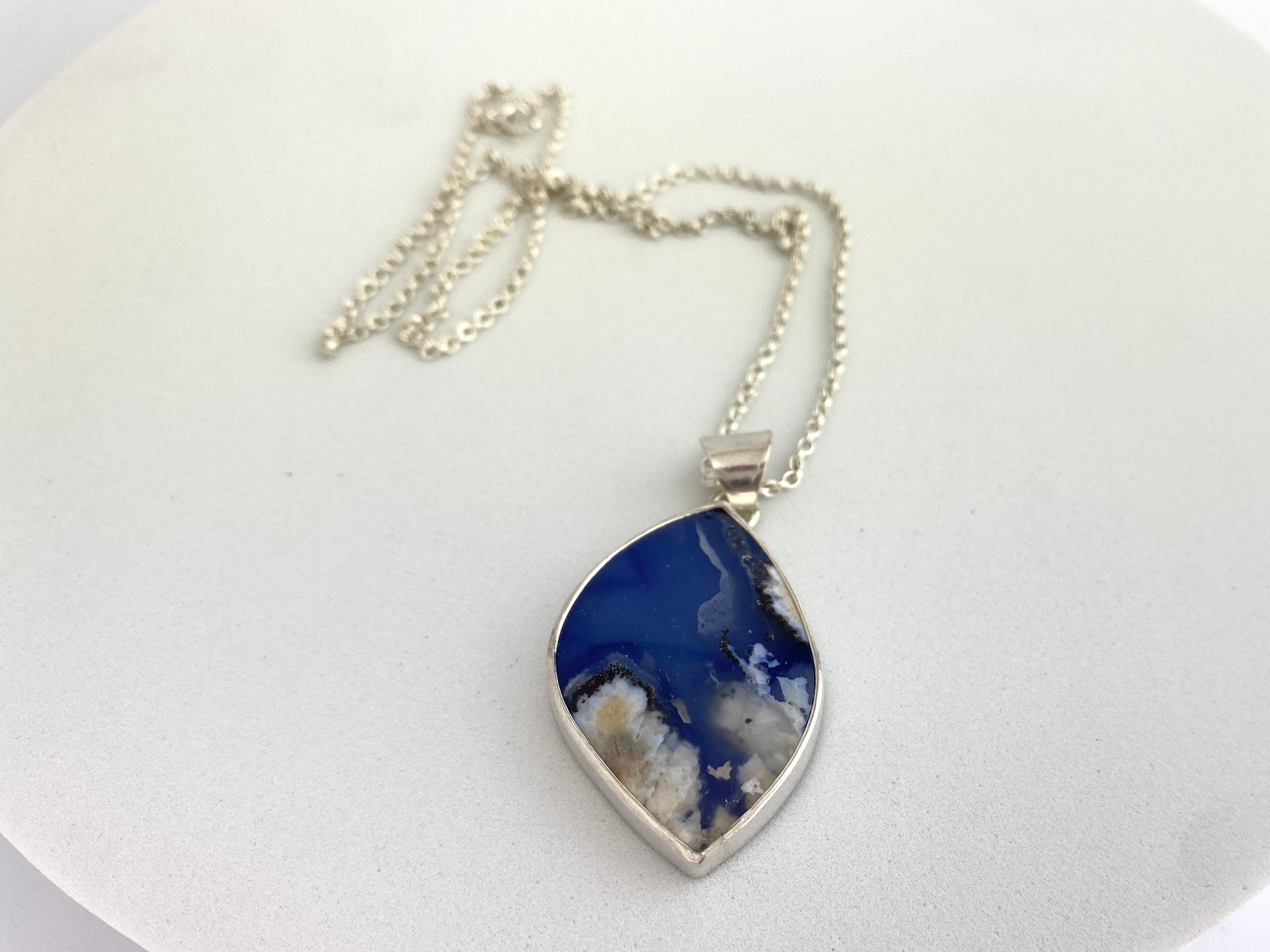 Necklace with a blue pendant on a white background